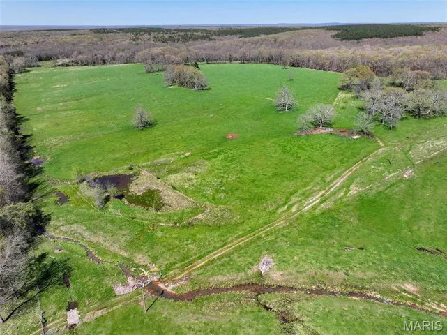 Aerial view of property and surrounding area featuring rural landscape