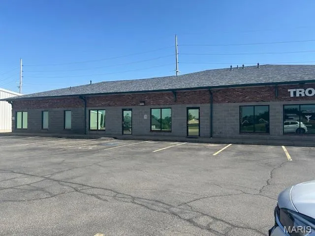 View of property featuring uncovered parking
