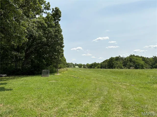 View of field at entrance to property featuring a view of rural / pastoral area
