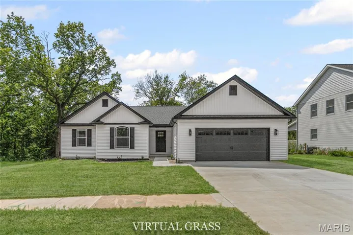 Modern farmhouse featuring a front lawn, board and batten siding, concrete driveway, and an attached garage
