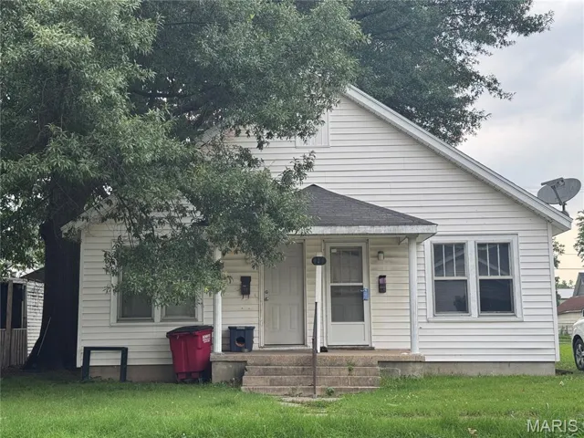 Bungalow with a front lawn and covered porch