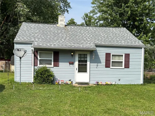 View of front of property featuring roof with shingles and a chimney