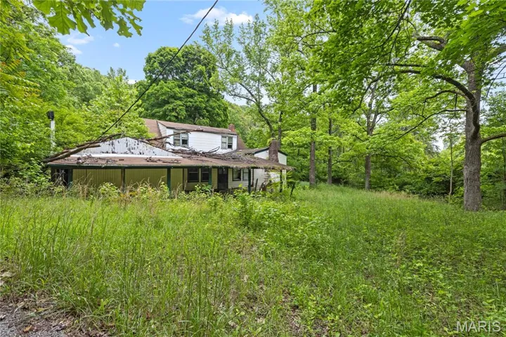 View of yard featuring a forest view