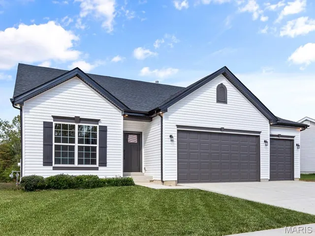 View of front of home featuring a garage, a front lawn, concrete driveway, and roof with shingles