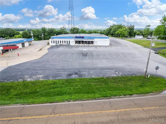 View of property featuring uncovered parking