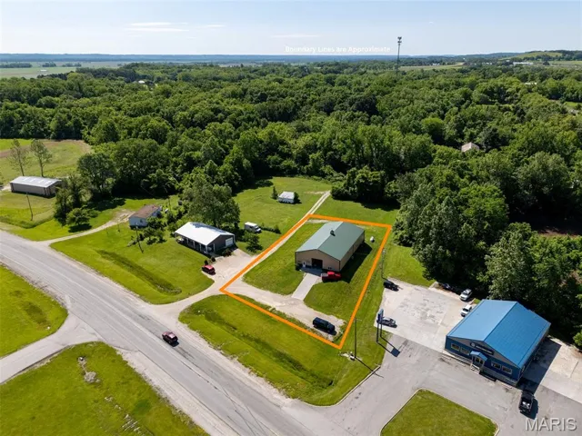 Aerial view of property's location with property boundaries highlighted and a forest