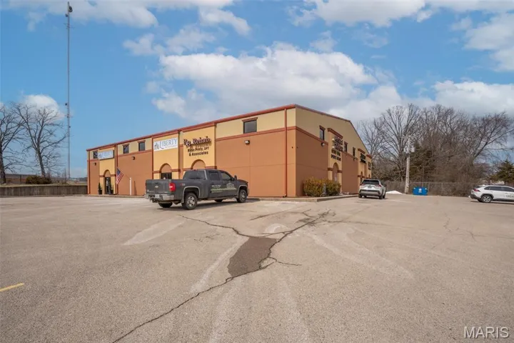View of property featuring uncovered parking