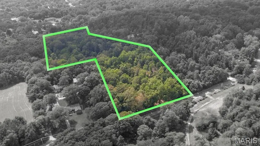 Aerial view of property and surrounding area featuring property parcel outlined