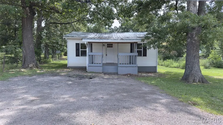 Bungalow-style house featuring a porch and a metal roof