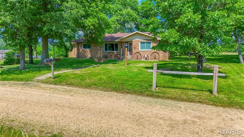Ranch-style home featuring a front yard and brick siding