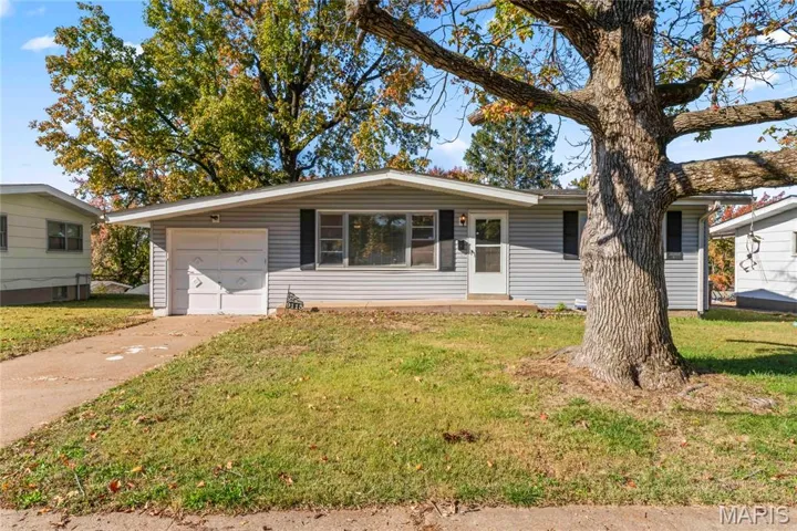 Single story home with a front yard, driveway, and an attached garage