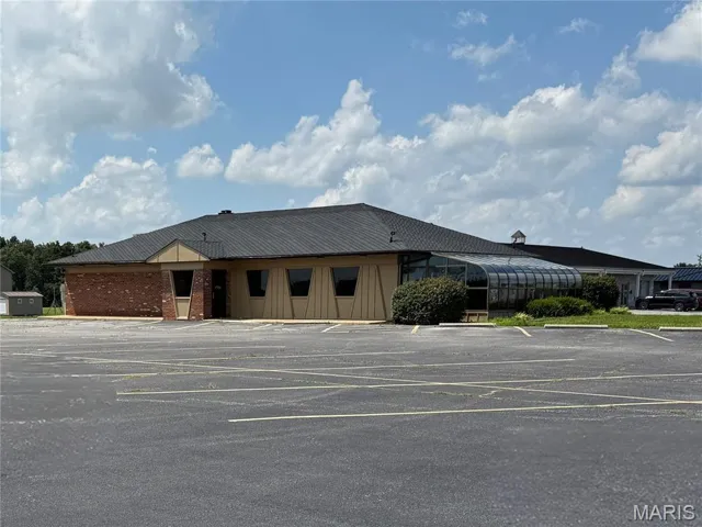 View of property with uncovered parking