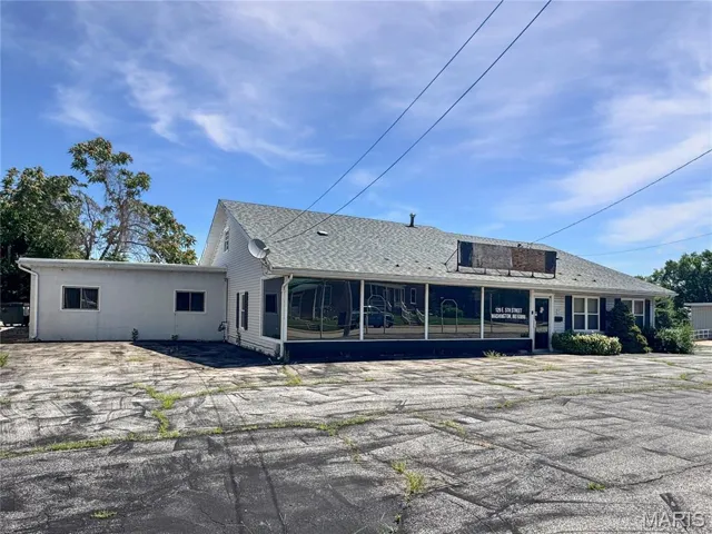 Rear view of property with a sunroom and a shingled roof