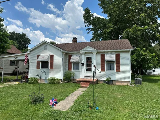 View of front of property with a front lawn and a chimney