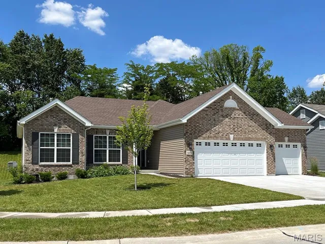 Single story home with a garage, a front yard, brick siding, and concrete driveway