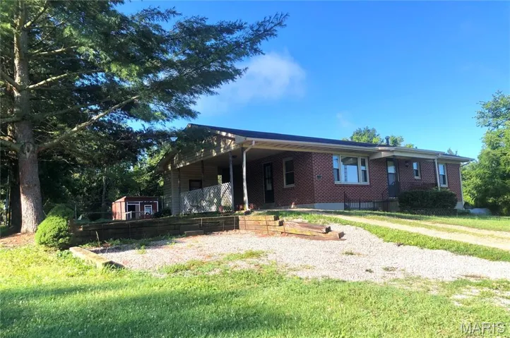 Ranch-style home with brick siding and a front yard