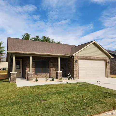 Ranch-style house with a shingled roof, a front lawn, driveway, an attached garage, and brick siding