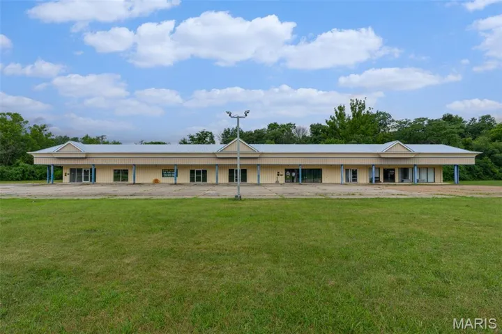 View of front of property featuring a front lawn and a porch