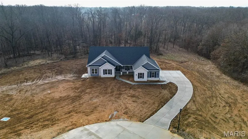 View from above of property featuring a heavily wooded area