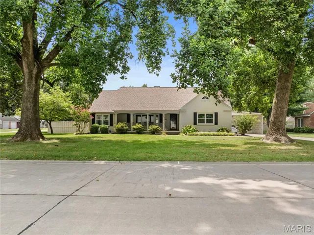 View of front of house featuring a front yard and roof with shingles