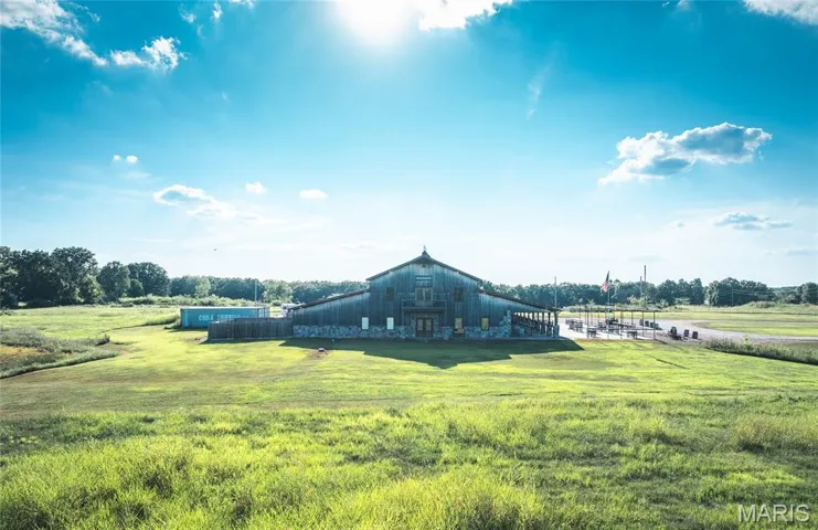 View of green lawn with a barn, a view of rural / pastoral area, and an outdoor structure