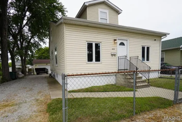 View of front of house featuring an outdoor structure and a garage