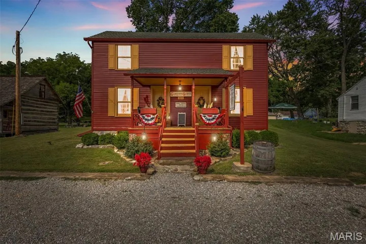 View of front of house featuring covered porch and a yard