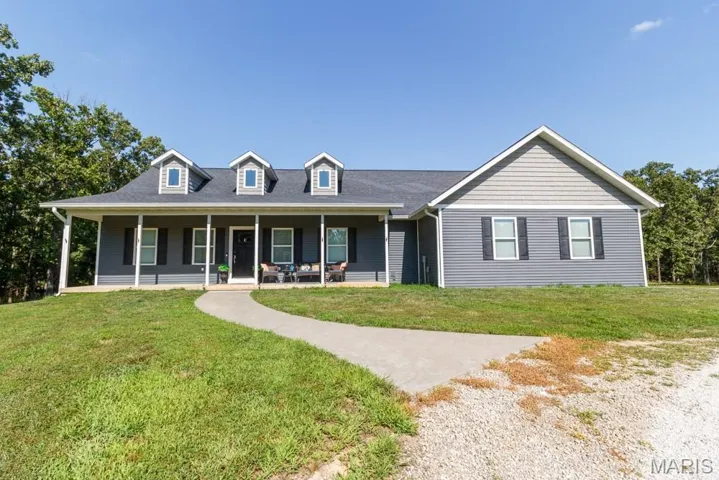 View of front of property with a front lawn and covered porch
