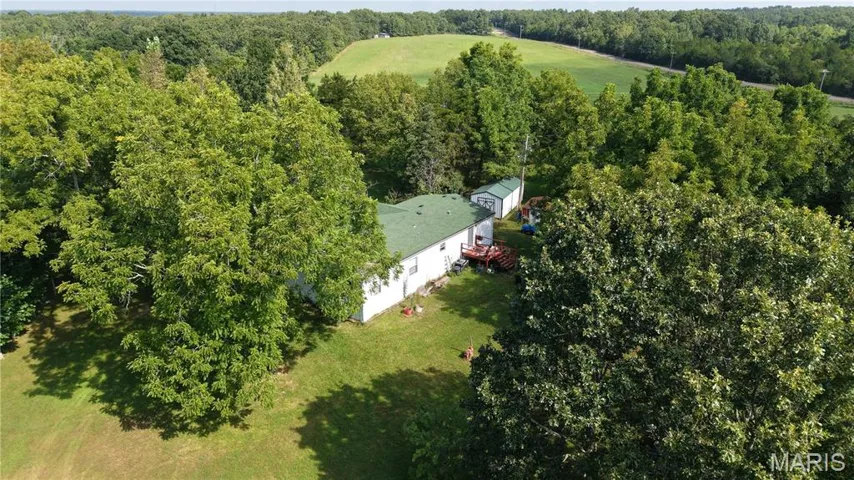View of subject property featuring a forest