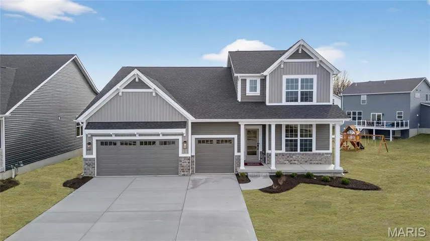 Craftsman-style home featuring covered porch, a front yard, board and batten siding, driveway, roof with shingles, and 3 car garage