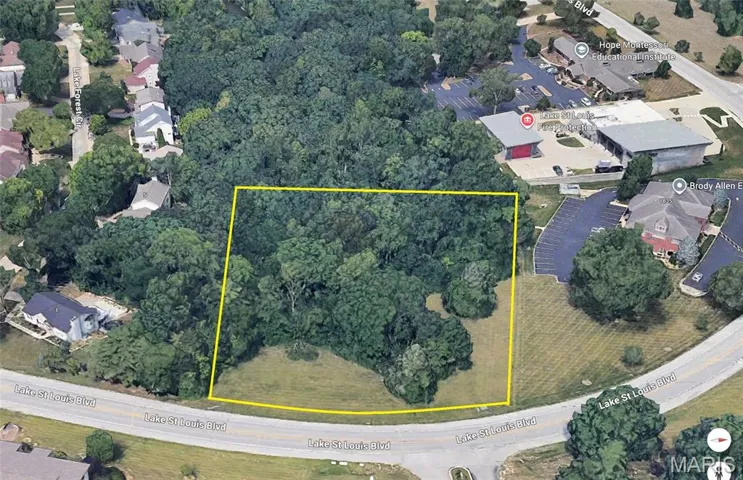 Aerial view of property and surrounding area with nearby suburban area and property parcel outlined