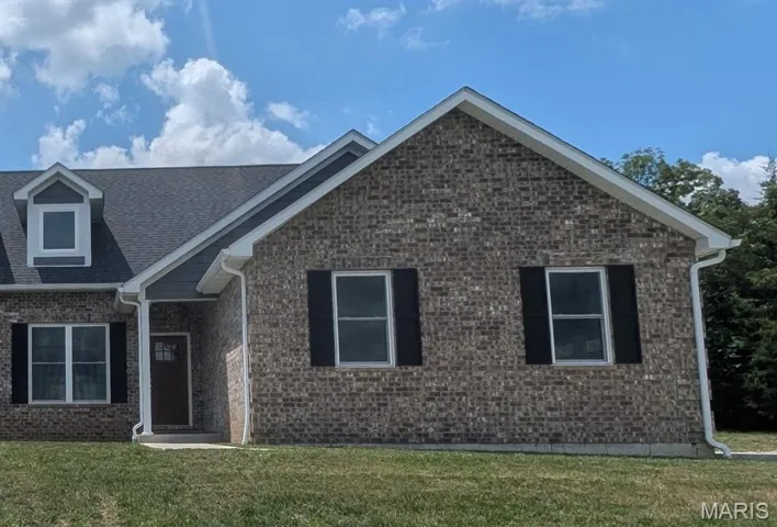 Ranch-style house with a front lawn and brick siding