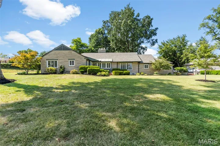 Ranch-style house with a front yard and a chimney