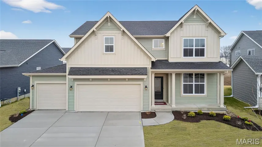 Craftsman house with board and batten siding, a shingled roof, driveway, and a front lawn