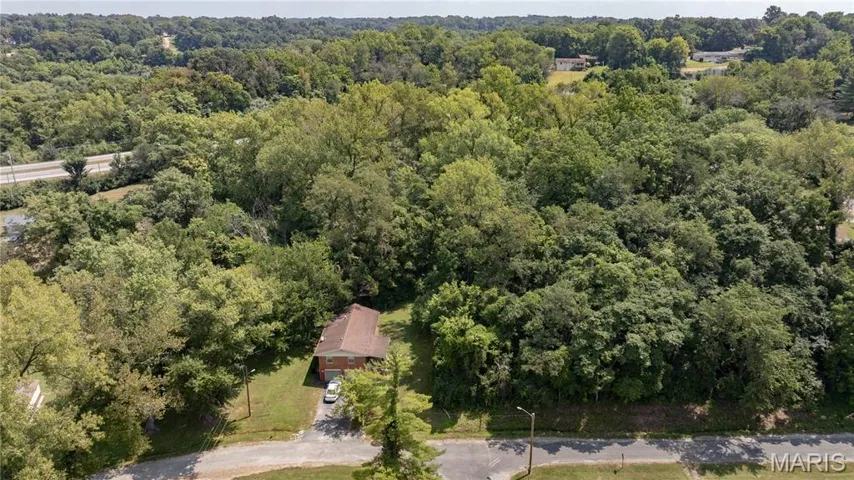 View of property location featuring a forest