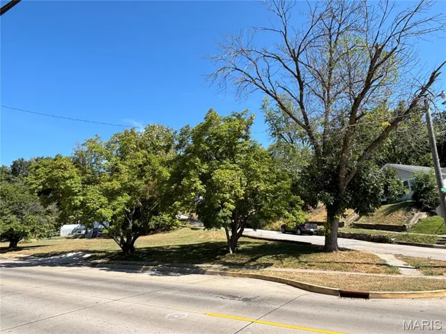 View of concrete road with curbs