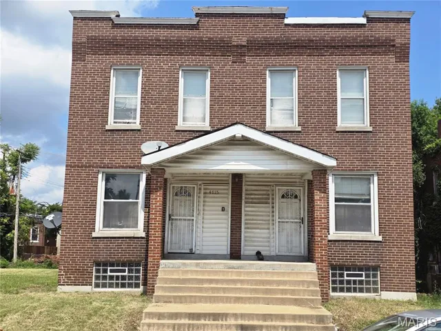 View of front of home featuring a porch and brick siding