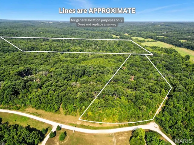 Aerial view of property's location featuring a heavily wooded area and property parcel outlined