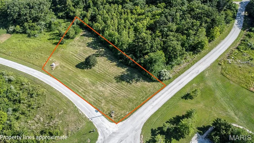 Aerial view of property and surrounding area featuring property boundaries highlighted