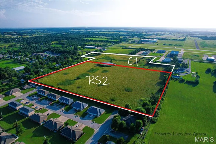 Aerial view of property and surrounding area with property parcel outlined