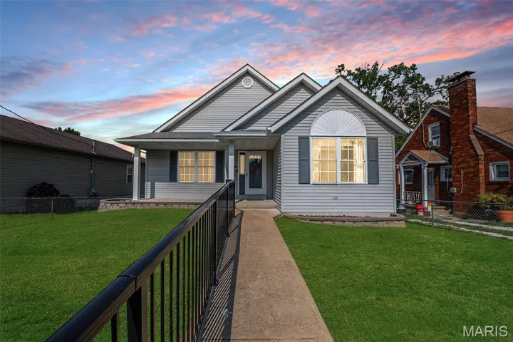 View of front of home featuring a fenced front yard and a porch