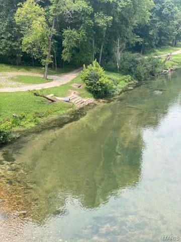 Surrounding community featuring a water view