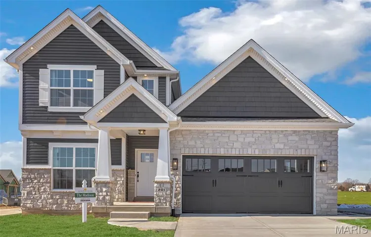 Craftsman inspired home featuring stone siding, driveway, a garage, and a front yard