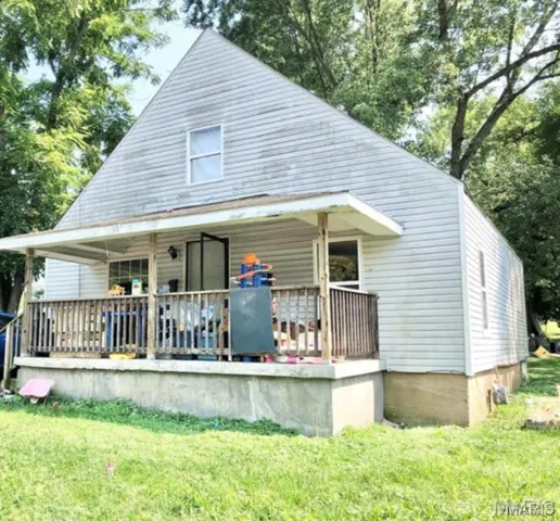 Bungalow-style home featuring a front lawn