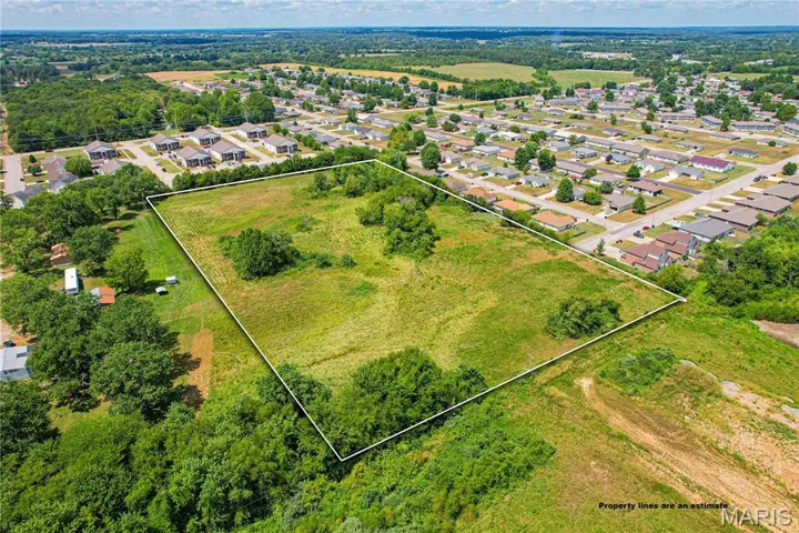 Aerial perspective of suburban area featuring property parcel outlined