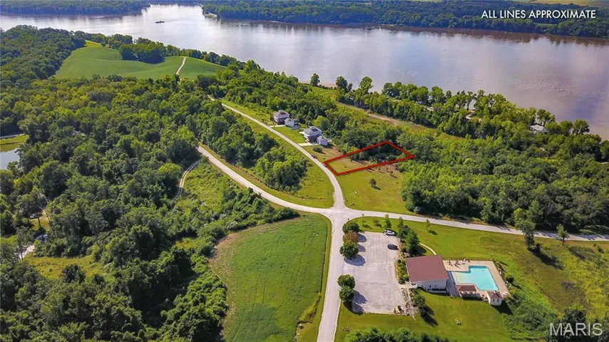 Aerial view of property and surrounding area featuring a forest and property boundaries highlighted