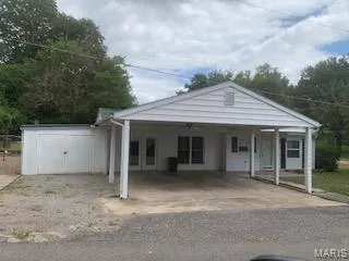 View of front of property with a carport and driveway