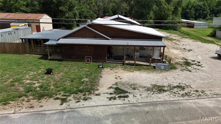View of front facade with a metal roof and a deck
