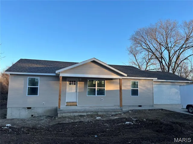 View of front of home with crawl space, roof with shingles, a porch, an attached garage, and driveway