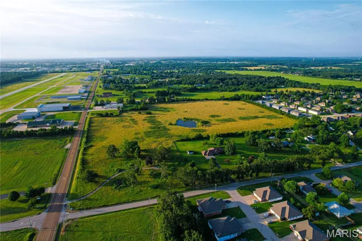 View of rural area with large plots for crops and nearby suburban area